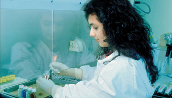 Lab technician working under a fume hood